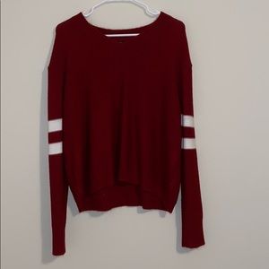 V neck red sweater with white stripes on sleeves